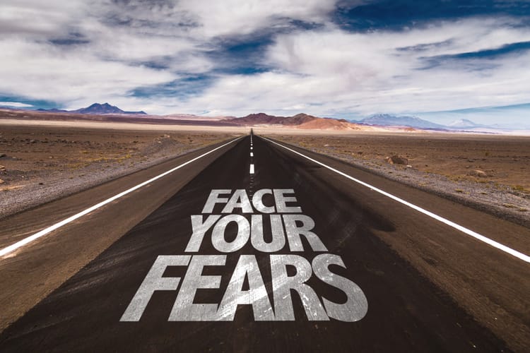 Face Your Fears written on desert road